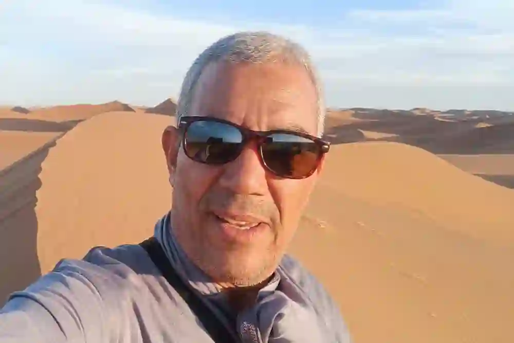 Mohamed Kimou, founder and local guide of AZUL TREK, in the Sahara dunes