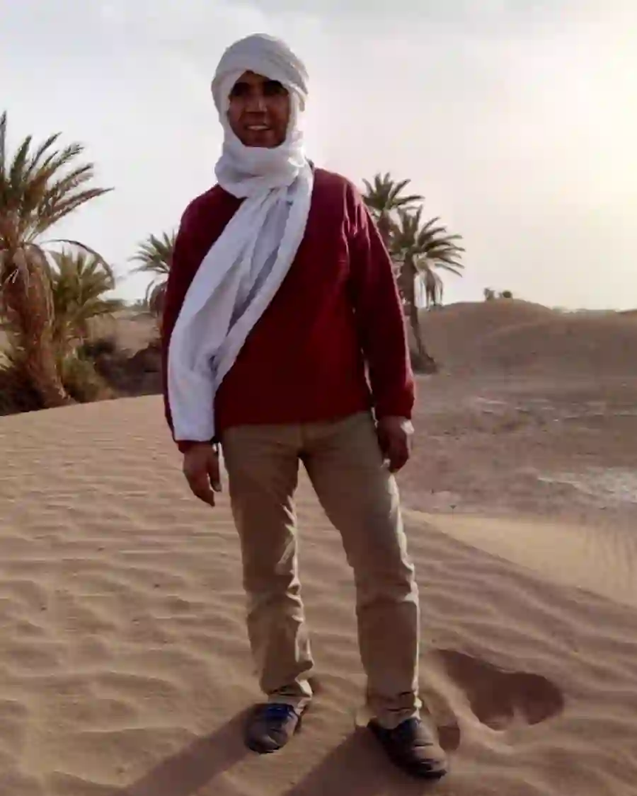 Mohamed Kimou standing in a palm oasis in Southern Morocco